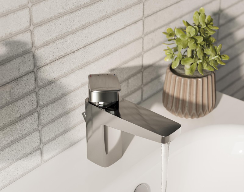 Chrome coloured VitrA Root Square tap running water into a white Integra Classic washbasin
