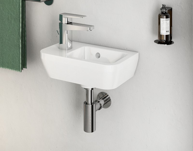 Chrome coloured VitrA Root Square tap on a free standing white washbasin